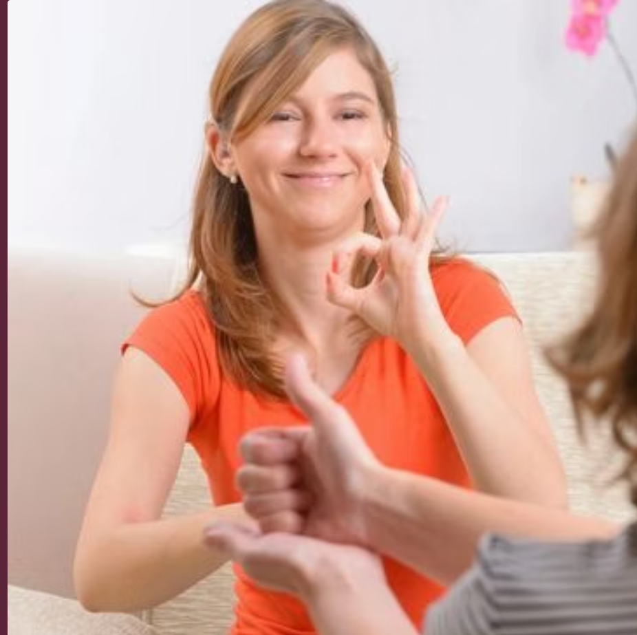 Several sensory toys on a coffee table next to a couch. left to right: Items include a cylindrical, rubber or hard plastic...